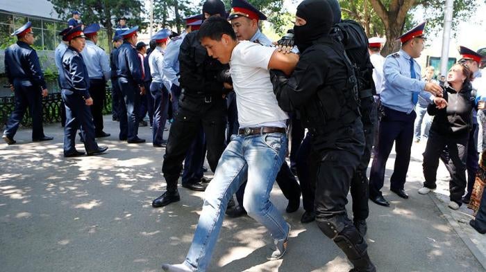 Police arrest protester in Kazakhstan. 