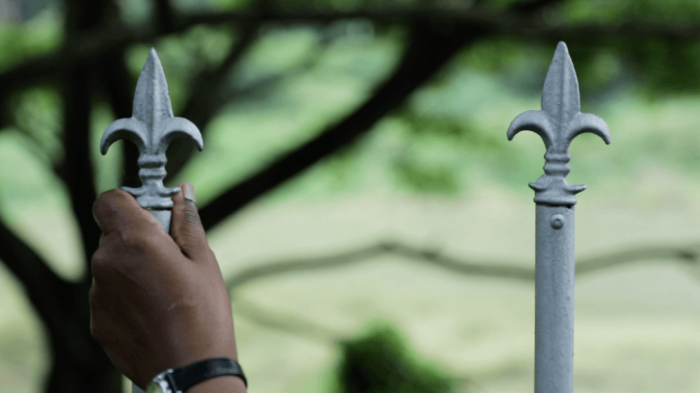 A picture of a hand holding a fence.