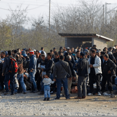 Migrants stand in line to enter a registration camp after crossing the border from Greece in Gevgelija.